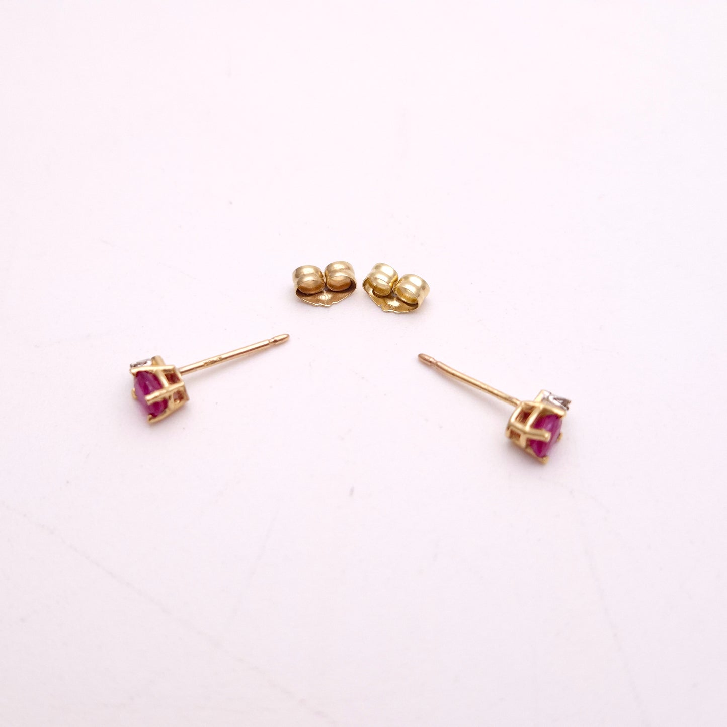 10ct Yellow Gold Oval Cut Ruby and Small Round Diamond Stud Earrings