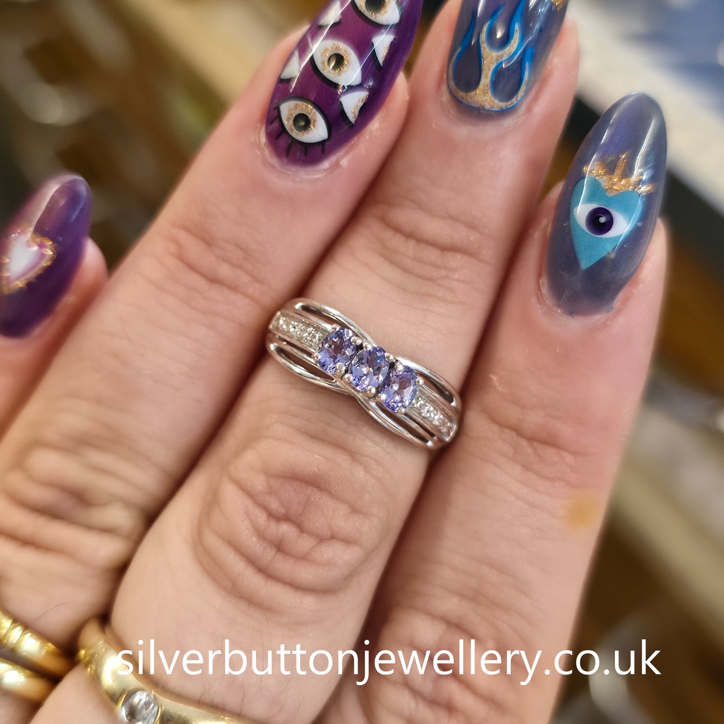 Sterling Silver Oval Cut Tanzanite Trilogy And Diamond Set Shoulders Ring