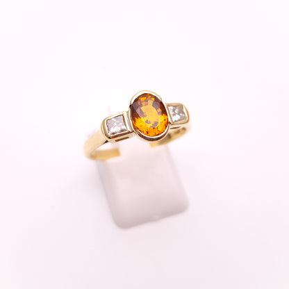 18ct Yellow Gold Oval Cut Orange Sapphire and Princess Cut Diamond Trilogy Ring