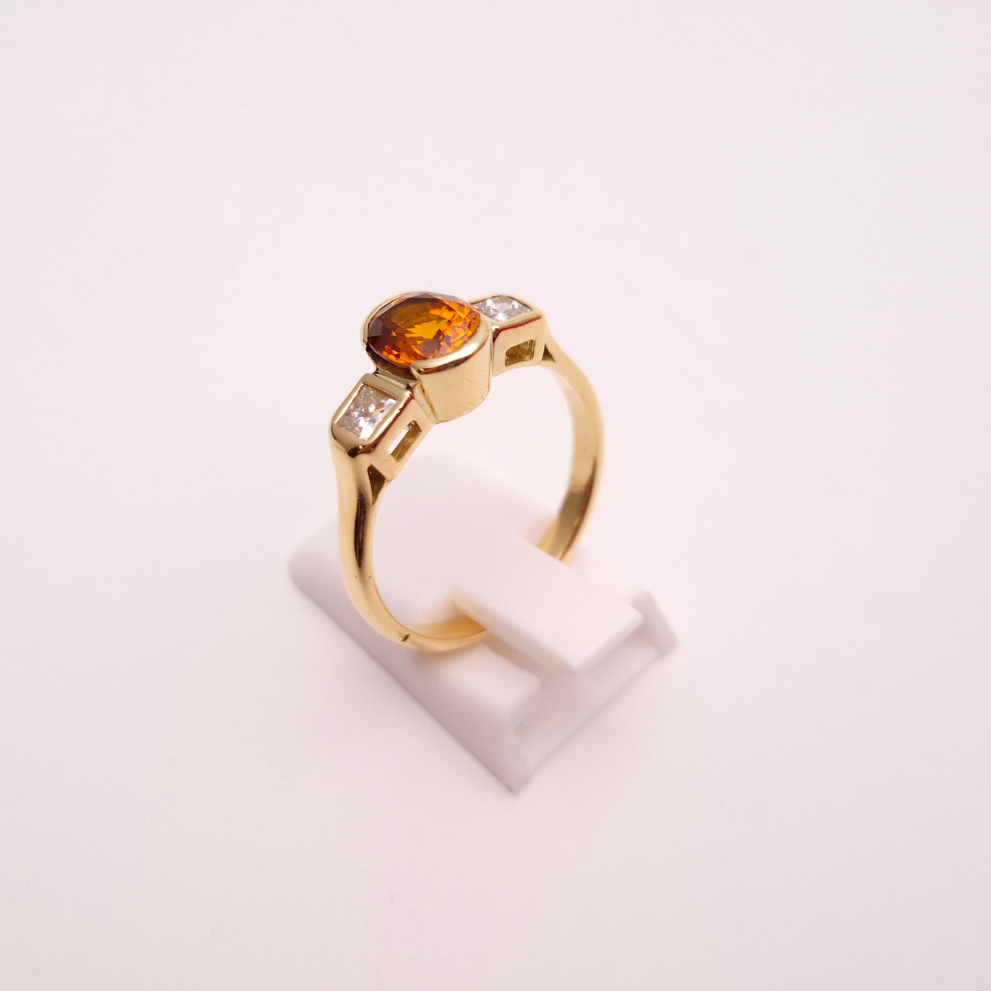 18ct Yellow Gold Oval Cut Orange Sapphire and Princess Cut Diamond Trilogy Ring