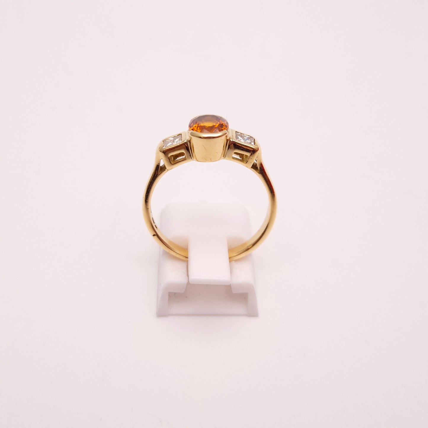 18ct Yellow Gold Oval Cut Orange Sapphire and Princess Cut Diamond Trilogy Ring