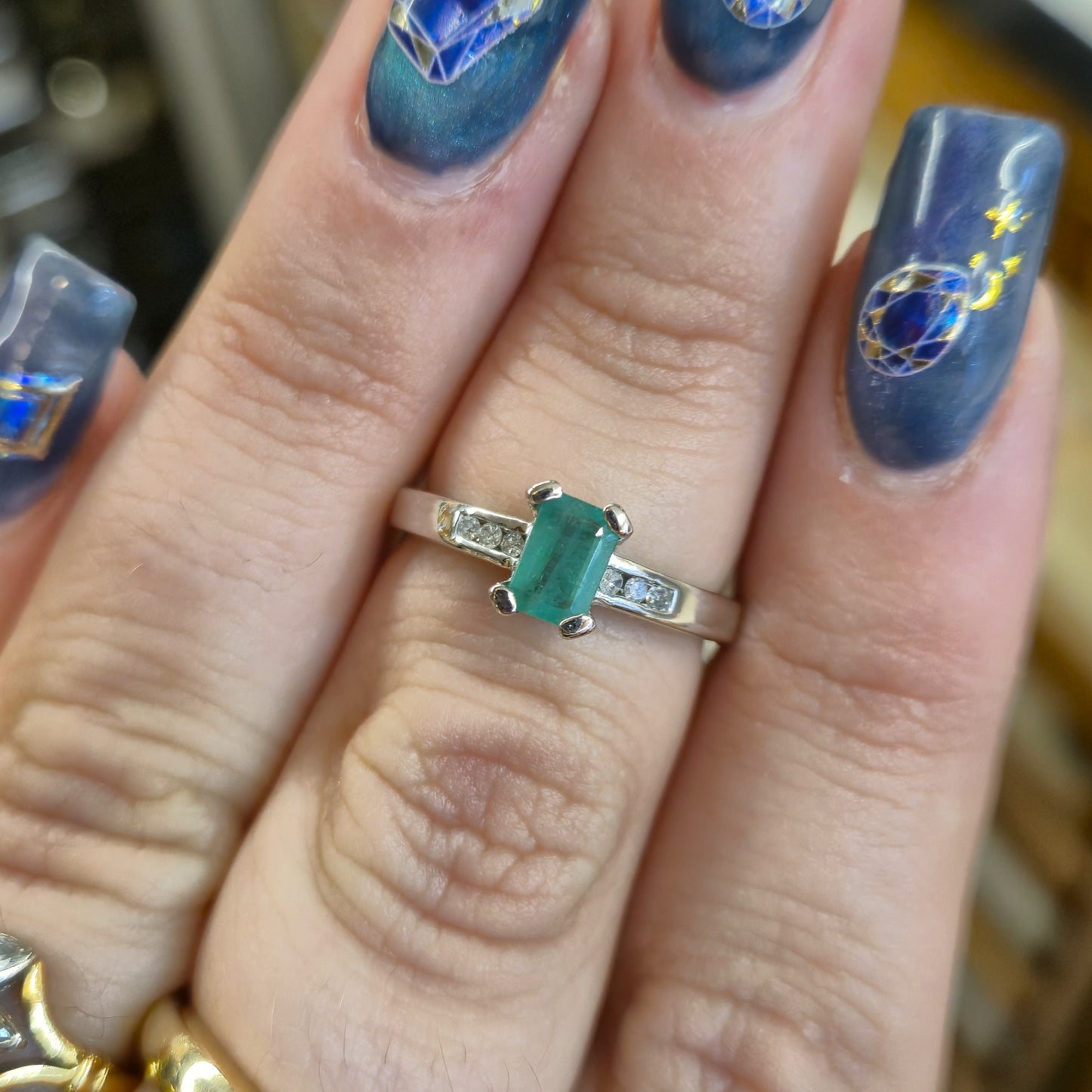 18ct White Gold Emerald Cut Emerald and Diamond Set Shoulders Ring