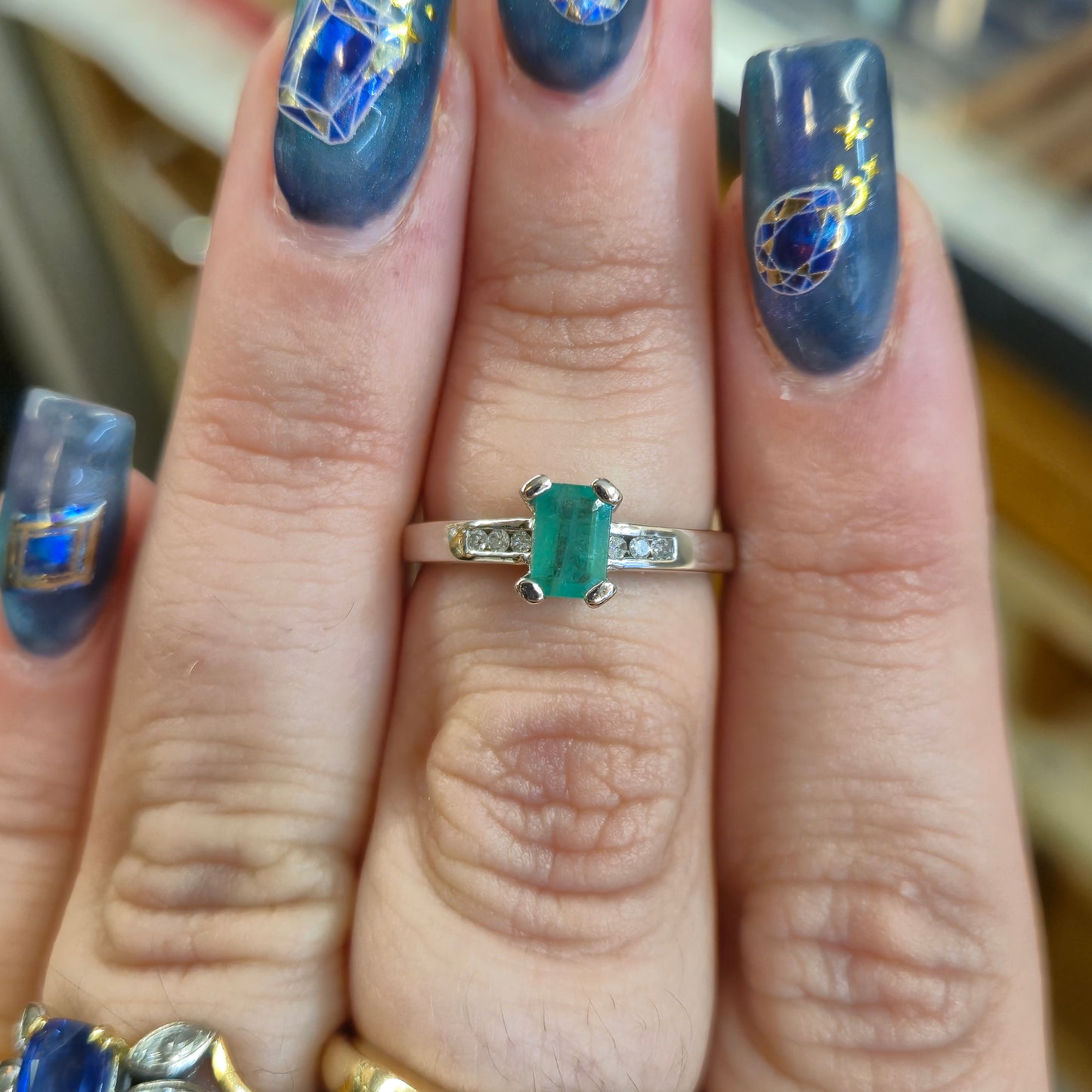 18ct White Gold Emerald Cut Emerald and Diamond Set Shoulders Ring