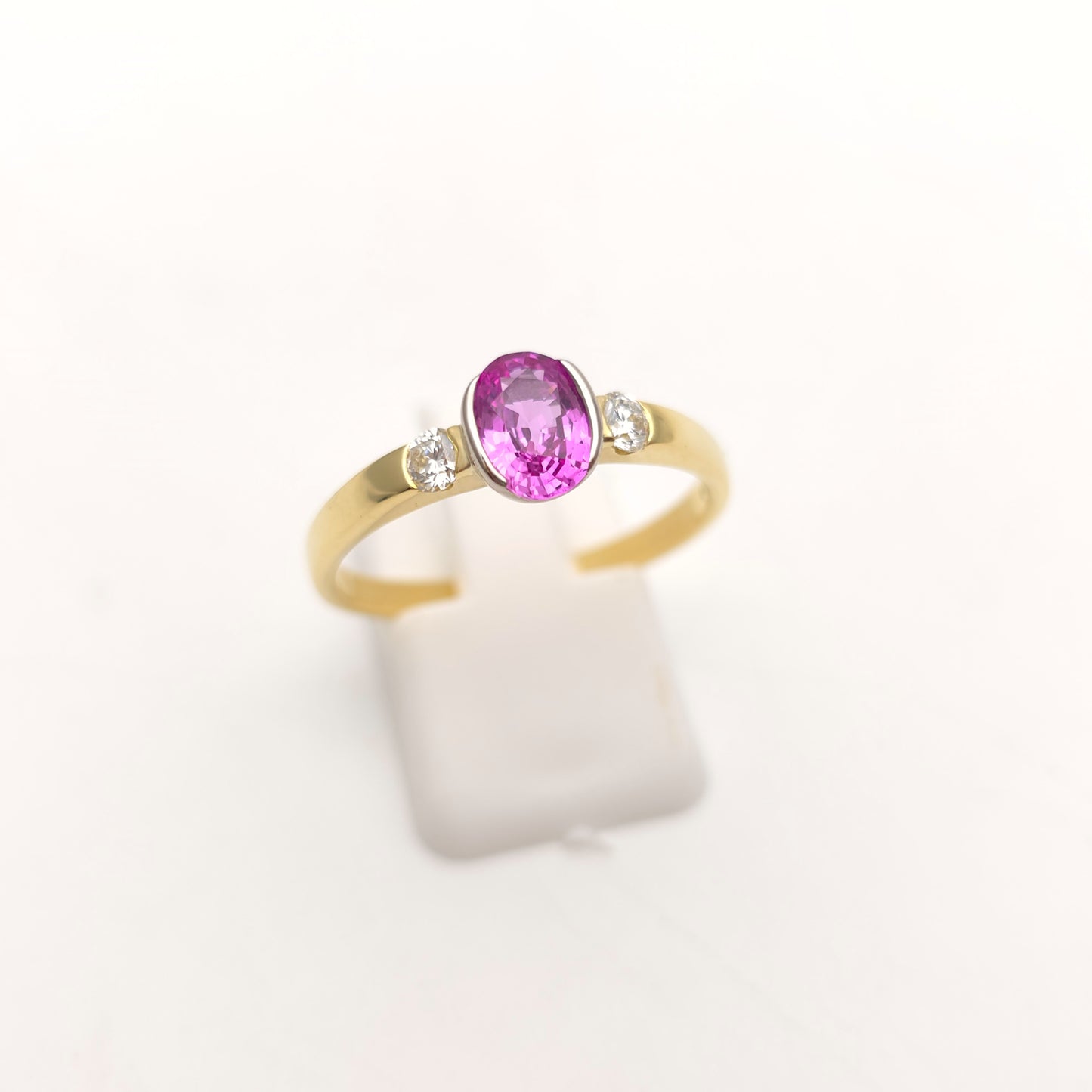 18ct Yellow Gold Oval Cut Half Bezel Set Pink Sapphire And Diamond Trilogy Ring