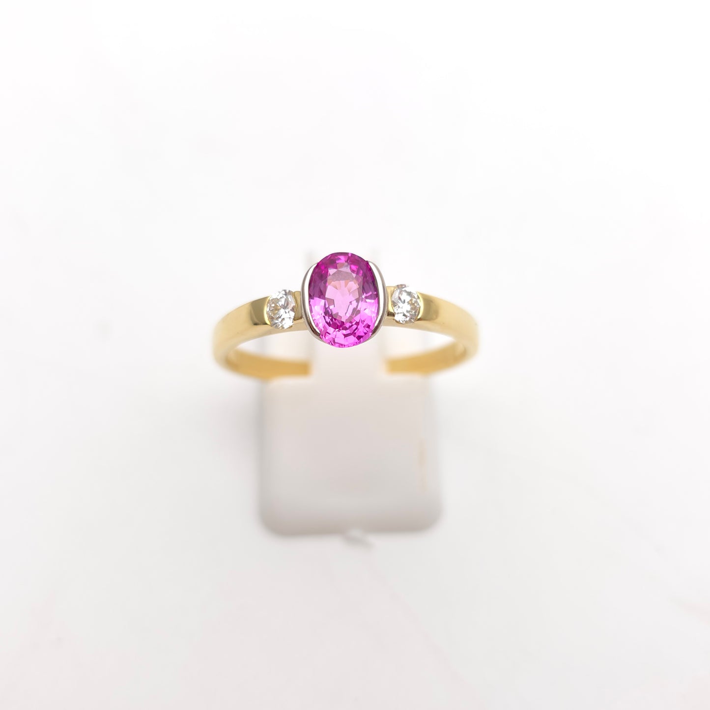 18ct Yellow Gold Oval Cut Half Bezel Set Pink Sapphire And Diamond Trilogy Ring