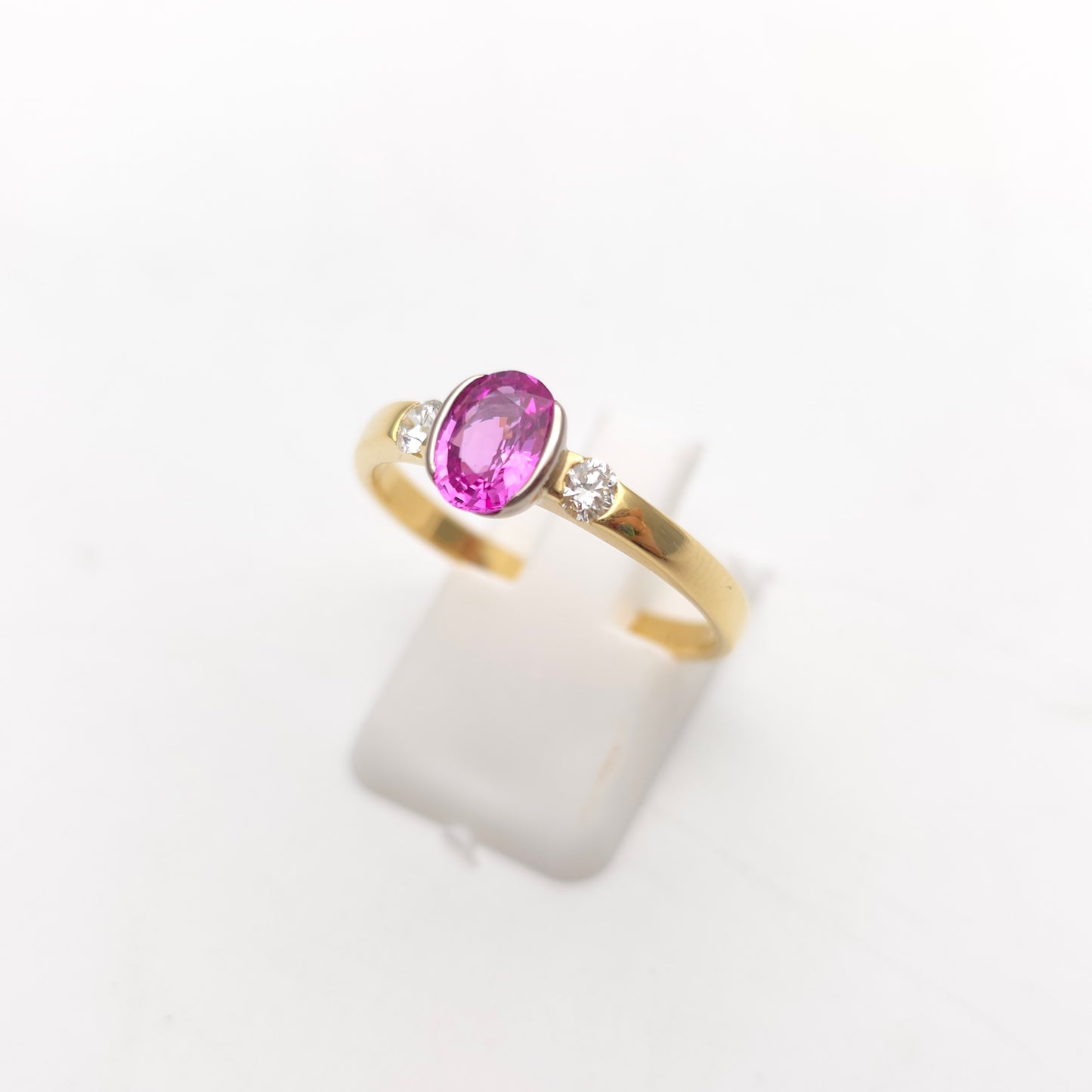 18ct Yellow Gold Oval Cut Half Bezel Set Pink Sapphire And Diamond Trilogy Ring
