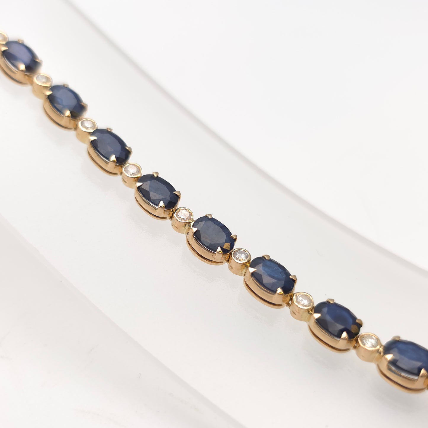 18ct Yellow Gold Oval Cut Sapphire And Small Round Cut Diamond Tennis Bracelet