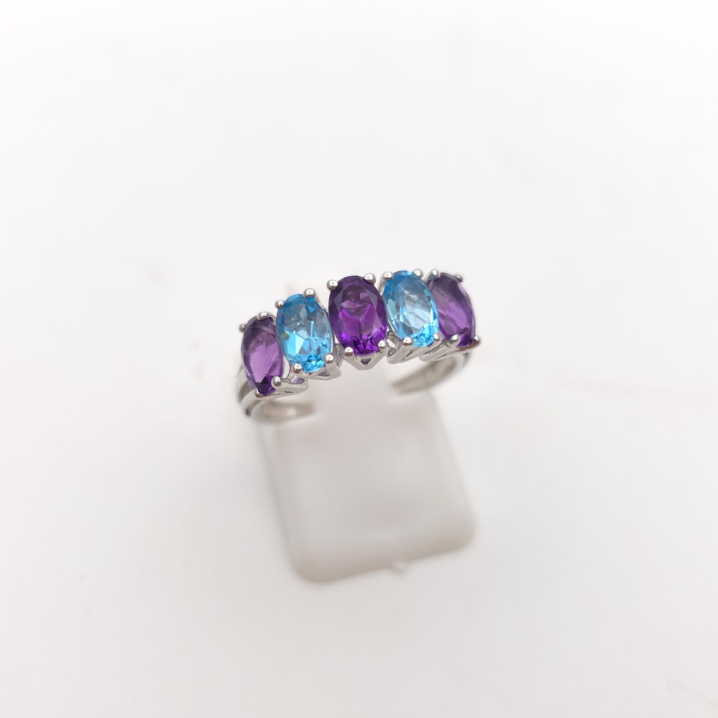 9ct White Gold Oval Cut Blue Topaz And Amethyst Half Eternity Row Ring