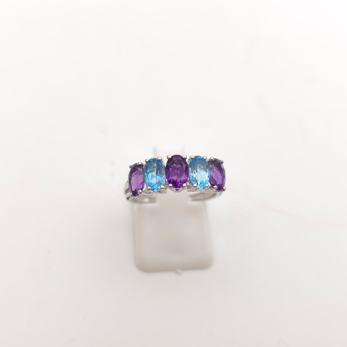 9ct White Gold Oval Cut Blue Topaz And Amethyst Half Eternity Row Ring