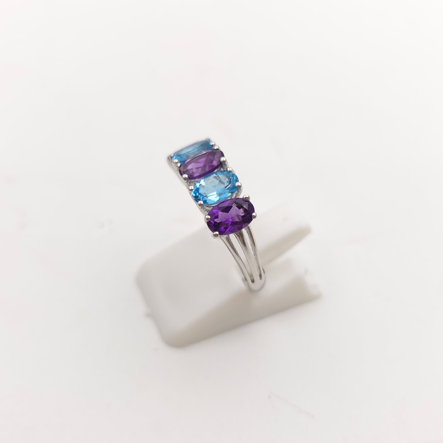 9ct White Gold Oval Cut Blue Topaz And Amethyst Half Eternity Row Ring