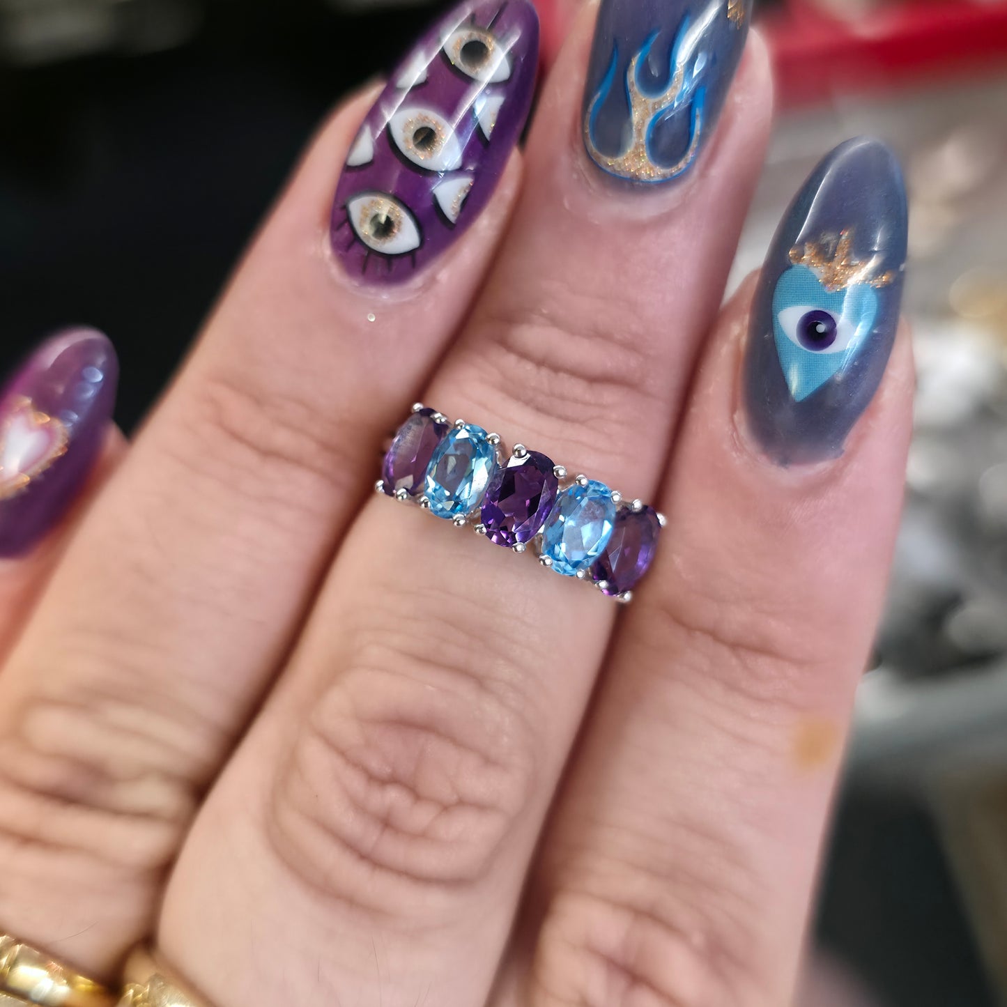 9ct White Gold Oval Cut Blue Topaz And Amethyst Half Eternity Row Ring