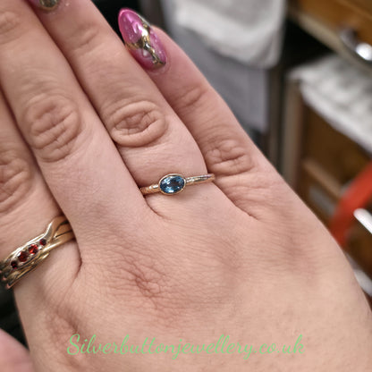 9ct Yellow Gold Oval Cut East West Set Blue Topaz Hollow Textured Band Ring