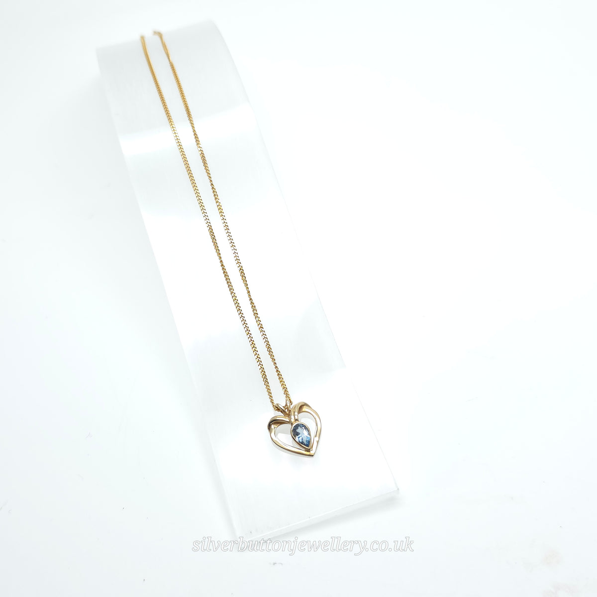 9ct Yellow Gold Pear Cut Blue Topaz Open Heart Pendant And Chain Necklace