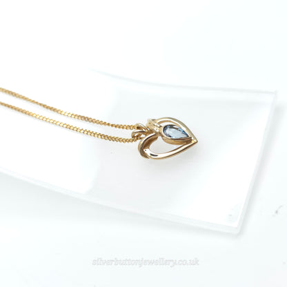 9ct Yellow Gold Pear Cut Blue Topaz Open Heart Pendant And Chain Necklace