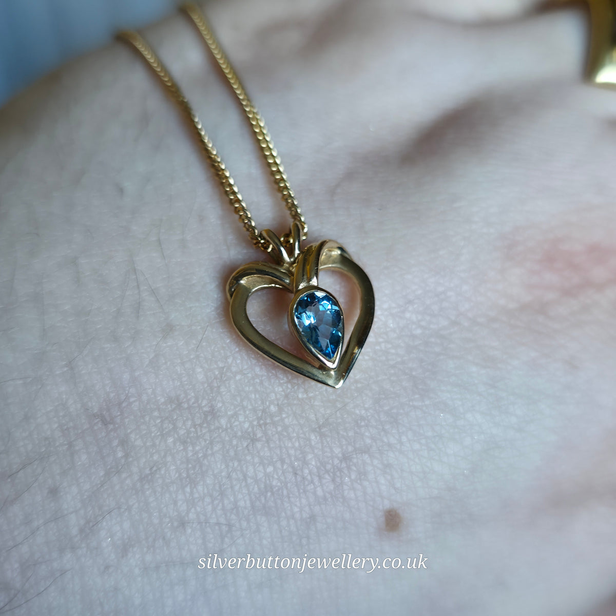 9ct Yellow Gold Pear Cut Blue Topaz Open Heart Pendant And Chain Necklace